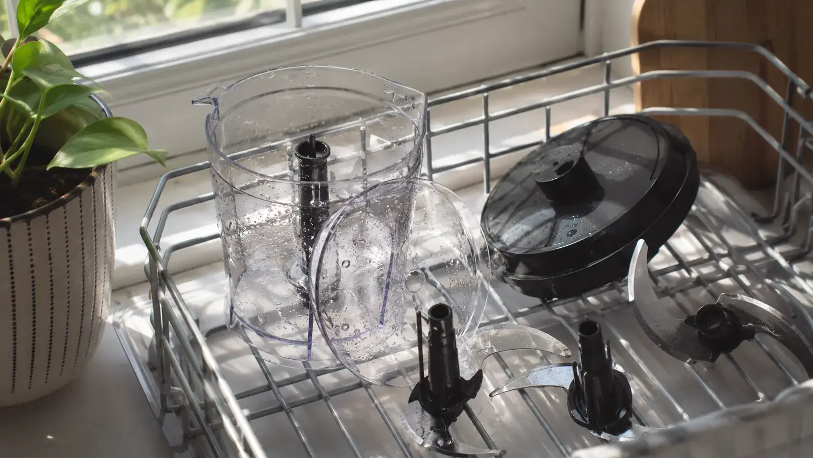 Disassembled Fullstar chopper parts drying in a dish rack next to the sink